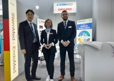 three team members of SternMed standing infront of trade show booth
